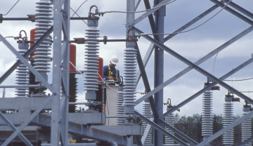 A photo of a worker in a power grid.