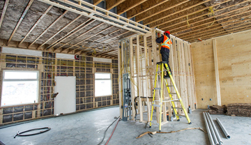Construction worker working inside a new house Construction worker working inside a new house