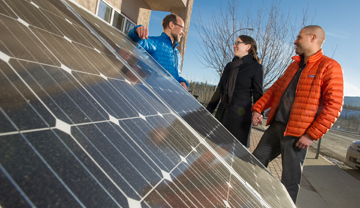 a couple talking to an energy advisor about solar panels