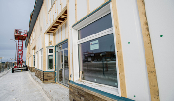 Foam insulation being installed on outside of building. Foam insulation being installed on outside of building.