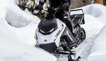 Snowmobile on a forested trail Snowmobile on a forested trail