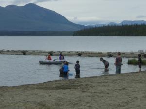 Children swimming at Pine Lake beach, Yukon
