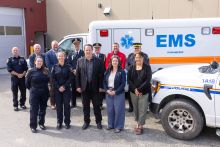 Minister of Health and Social Services, Brad Cathers; Minister of Justice, Minister, Laura Lang and Minister of Community Services and Minister responsible for the Yukon Lottery Commission, Cory Bellmore pose alongside first responders for the 10 year anniversary since 911 service was expanded to rural Yukon communities, recognizing the continued role of Yukon Emergency Medical Services, RCMP, fire services, and other partners in supporting access to emergency response in Yukon communities.